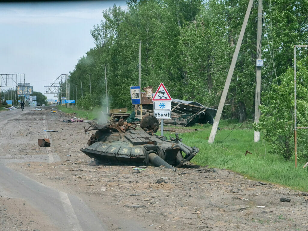 Ein zerstörter Panzer steht am Straßenrand in Charkiw.